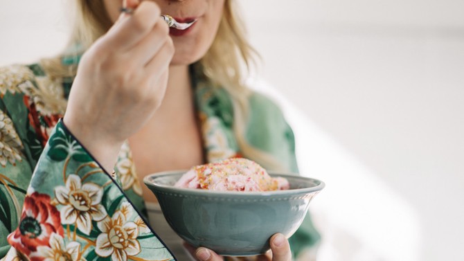 Woman eating bowl of ice cream