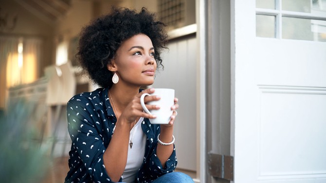 Woman relaxing with mug of coffee