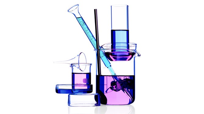 Vials and beakers containing blue liquid