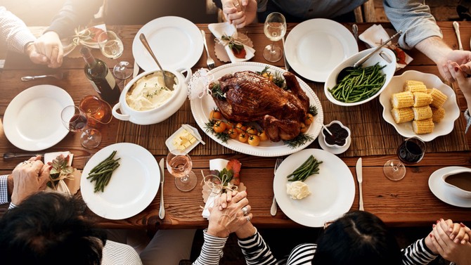 Family gathered around the Thanksgiving turkey
