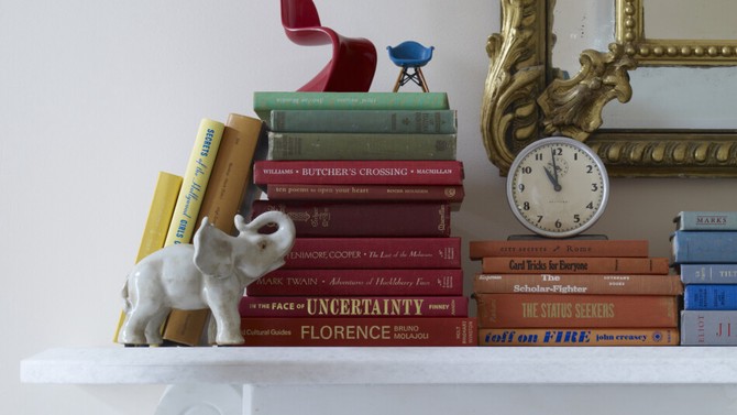mantel decorated with heirlooms and books