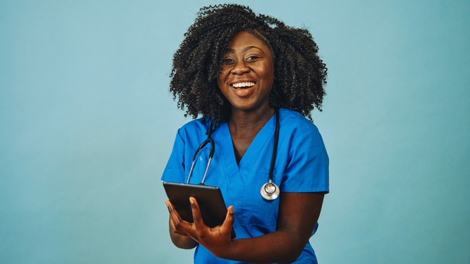 Black woman doctor in blue scrubs