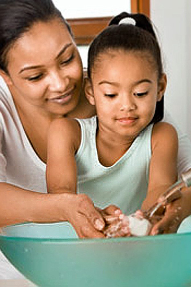 Mother and daughter washing hands