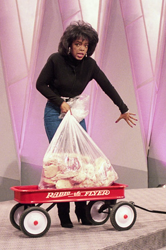Oprah with a wagon loaded with 67 pounds of fat