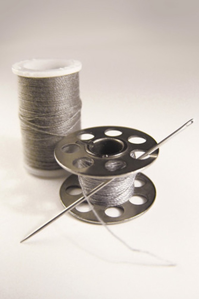 Silver thread, spool and needle