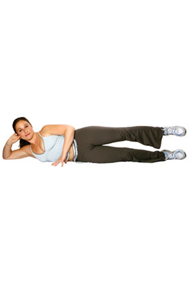 Woman doing side-lying leg raises on mat