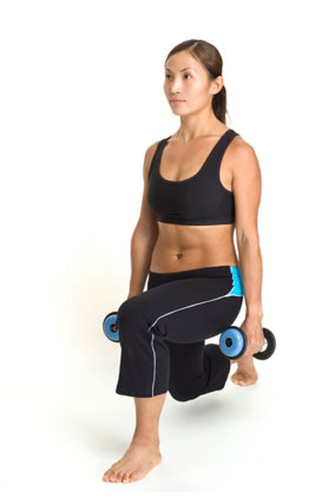Woman doing lunge with weights