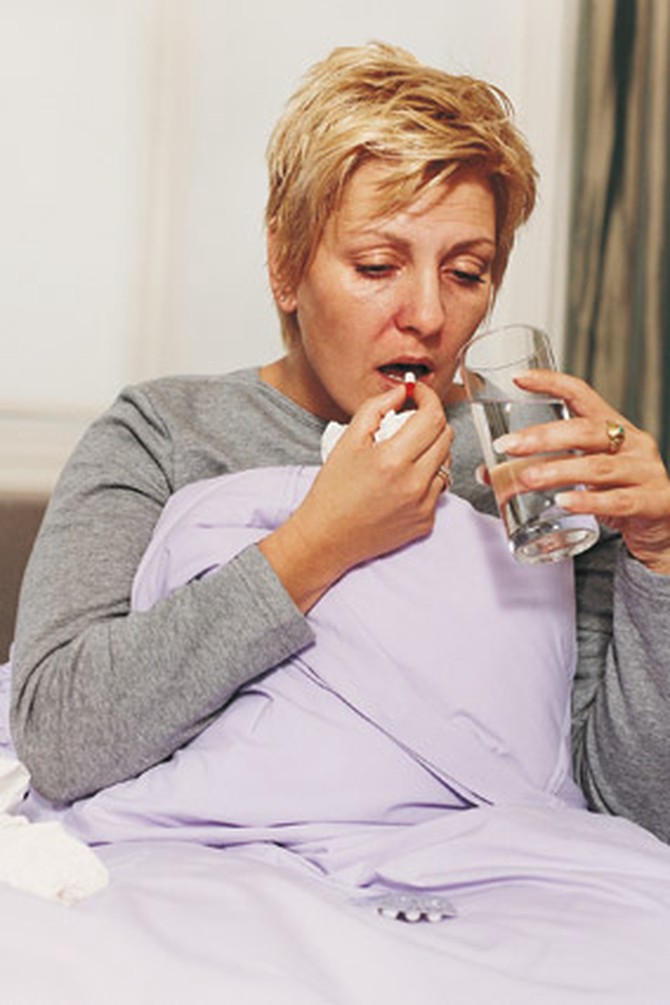 Woman taking medication before bed