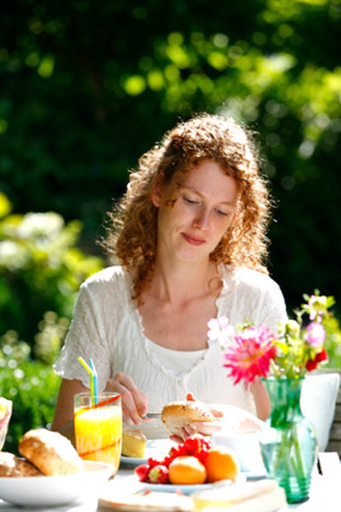 Woman having breakfast outside