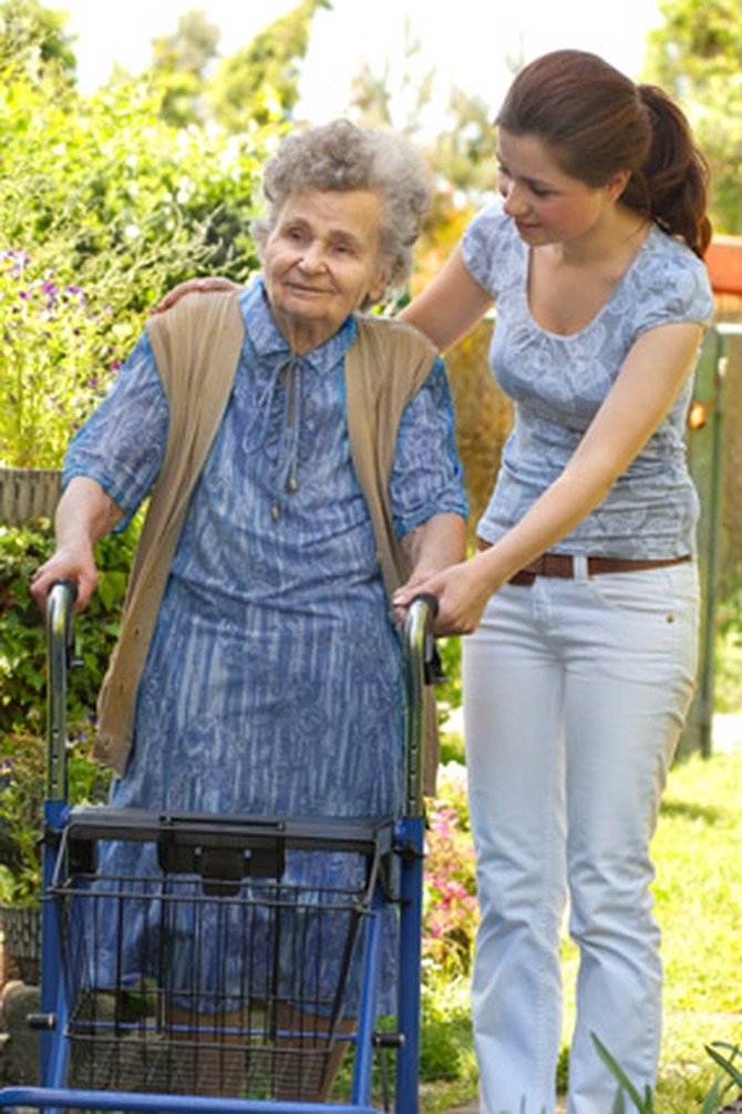 Young woman volunteering with elderly woman