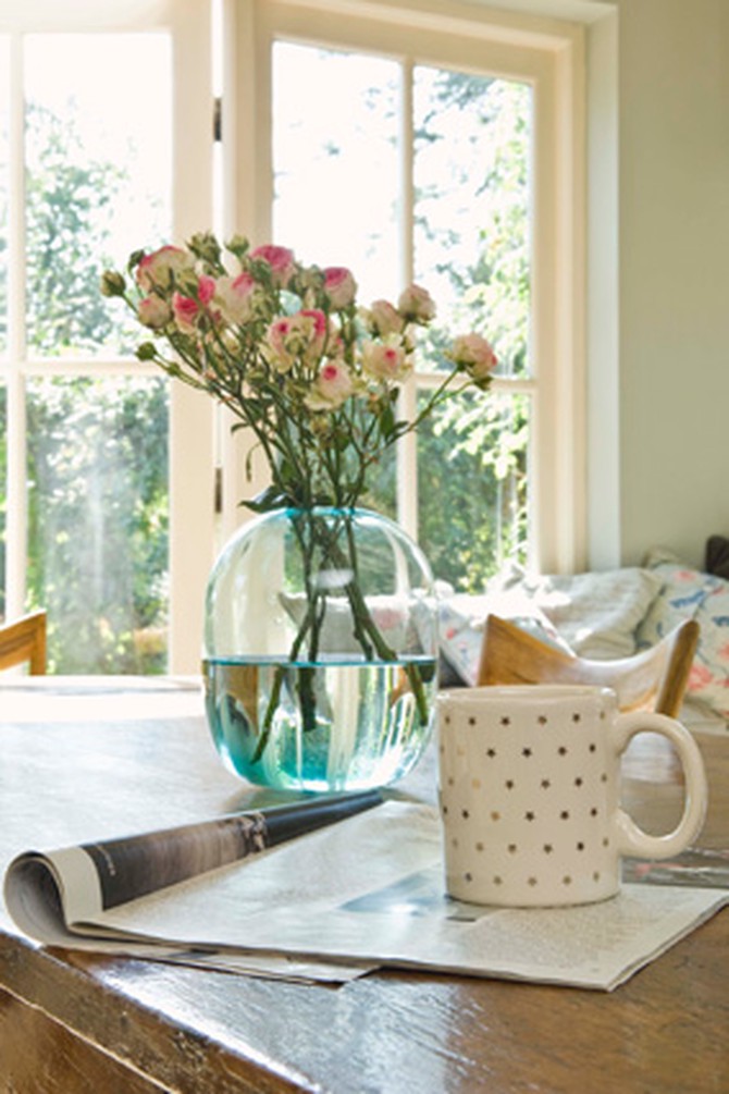 open magazine and coffee cup on table in home