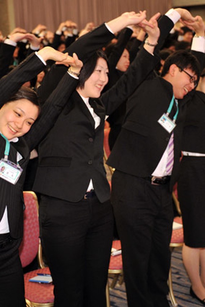 Japanese office workers doing organized stretching