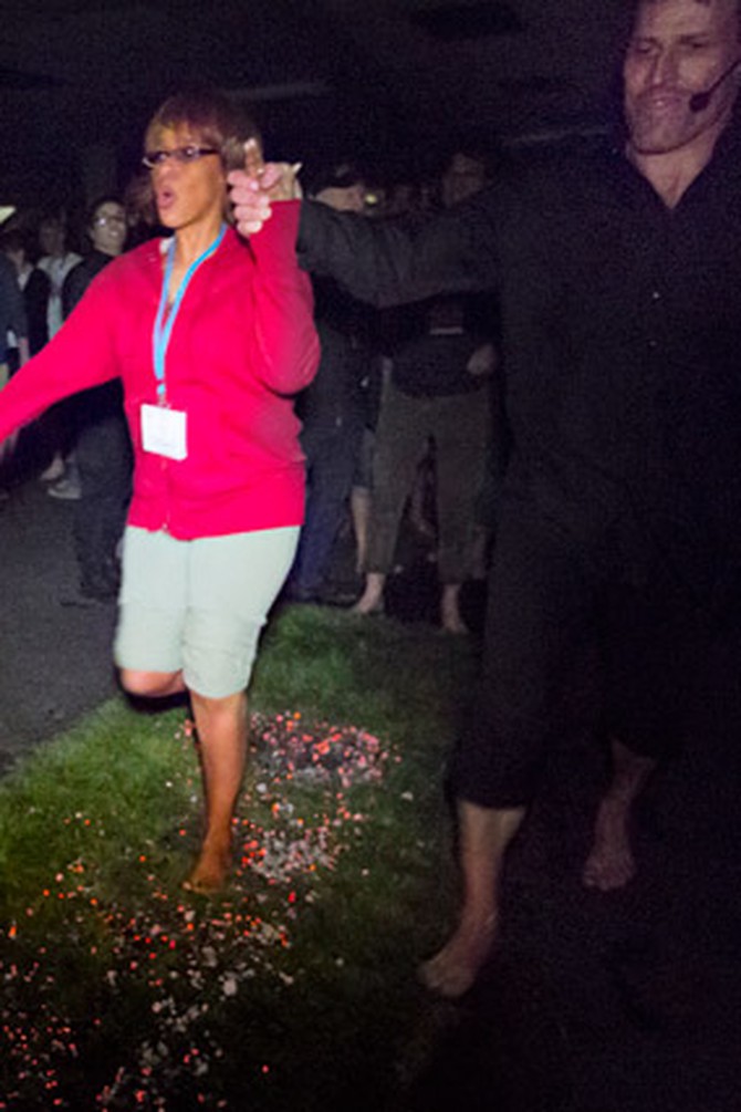 Gayle King walking on coals with Tony Robbins