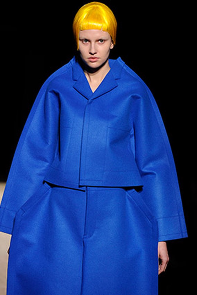Runway model wearing oversize blue coat