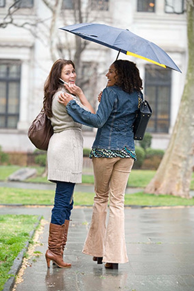 Woman sharing her umbrella