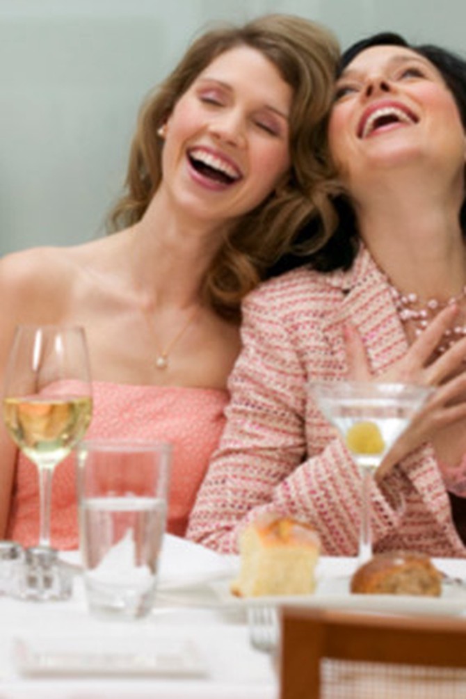 women laughing at a table