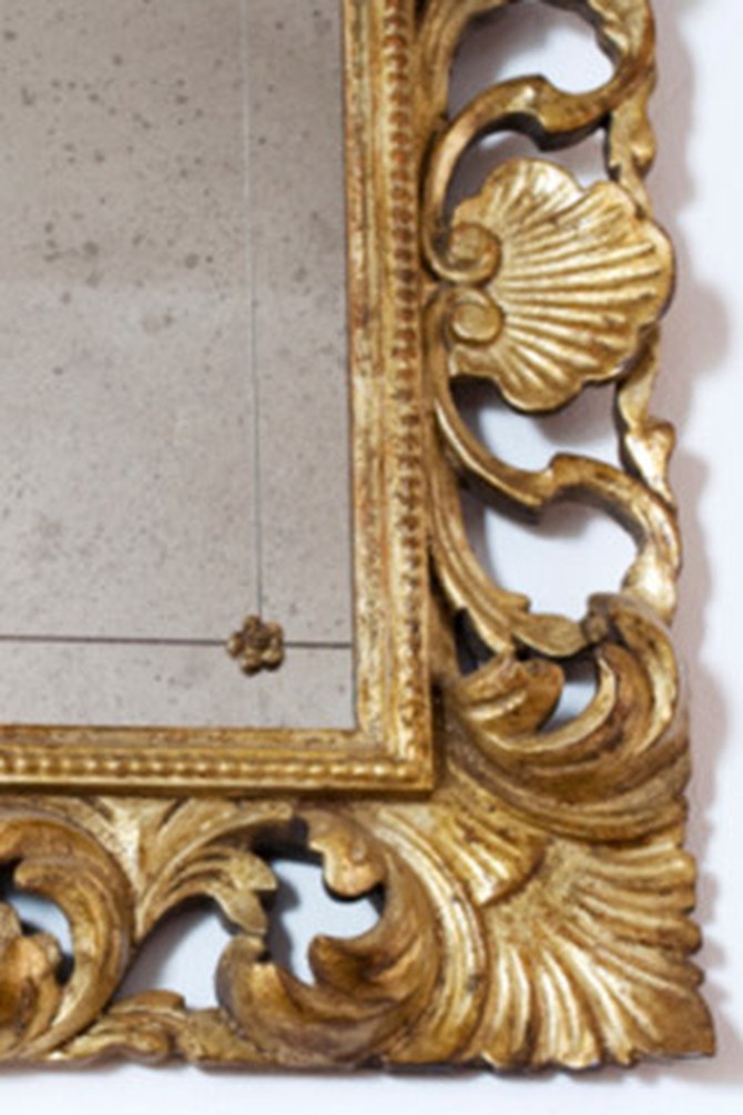 Corner of mirror in ornate gold frame