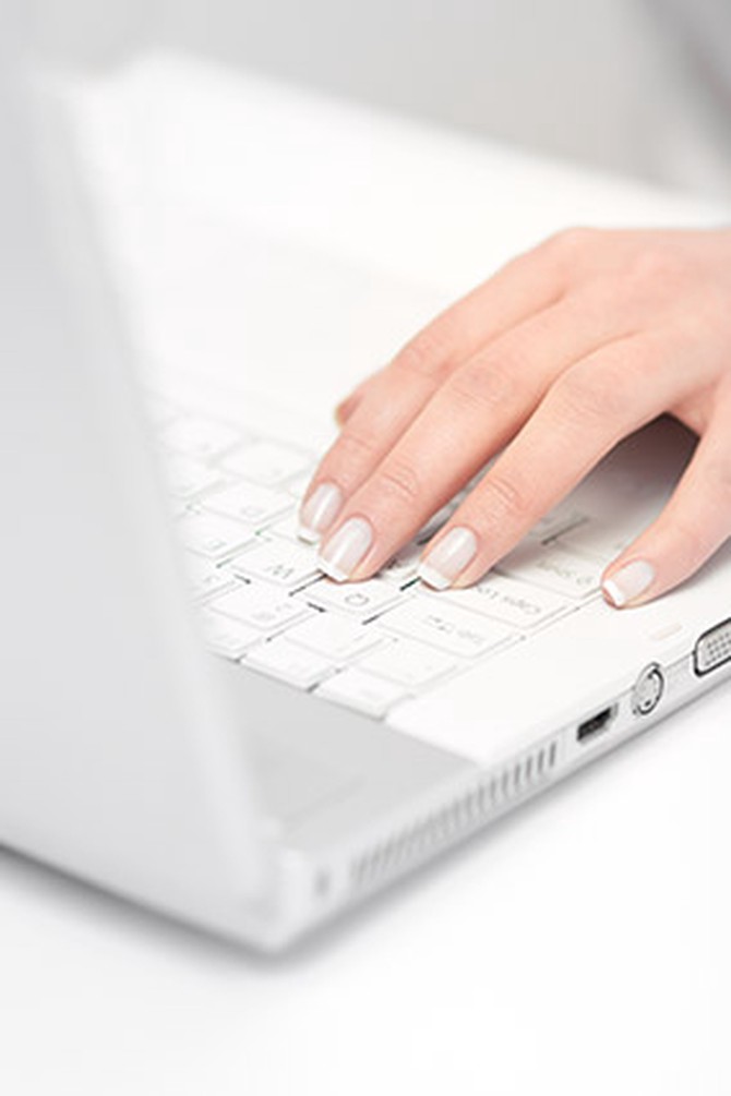 Woman's hand on laptop keyboard