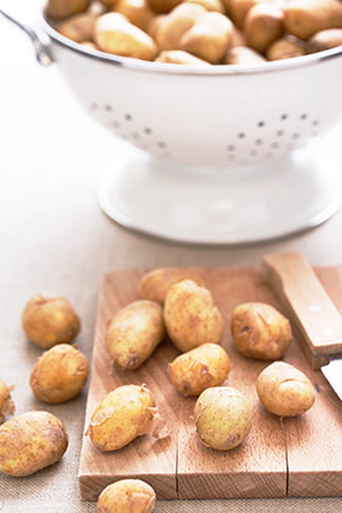 New potatoes in colander and on cutting board