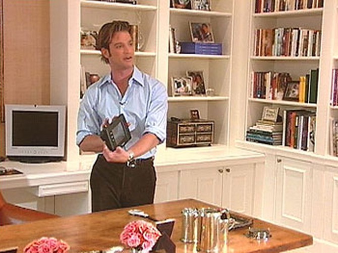 Nate shows Oprah the master remote control.