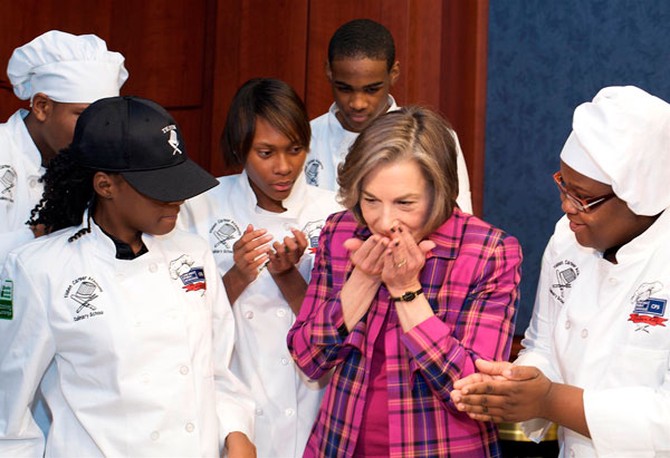 U.S. Rep. Jan Schakowsky smells fresh basil from a student-developed healthy lunch recipe.