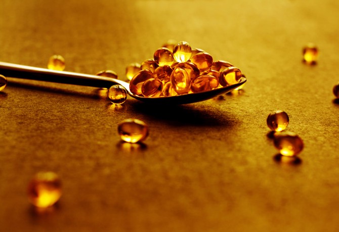 Fish oil supplements in a spoon