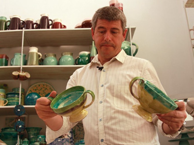 Keith Johnson looking a ceramics in Argentina