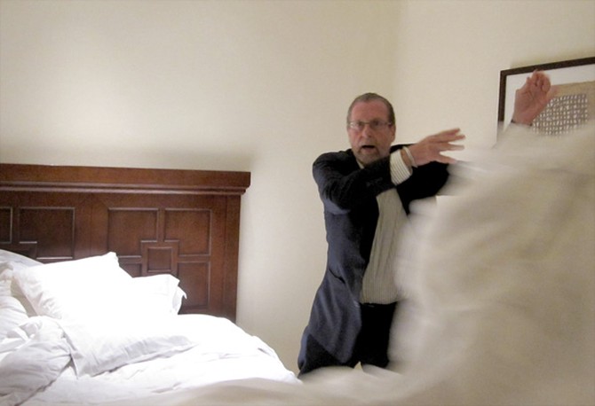 Peter Greenberg demonstrates how he deals with dirty hotel bedspreads.