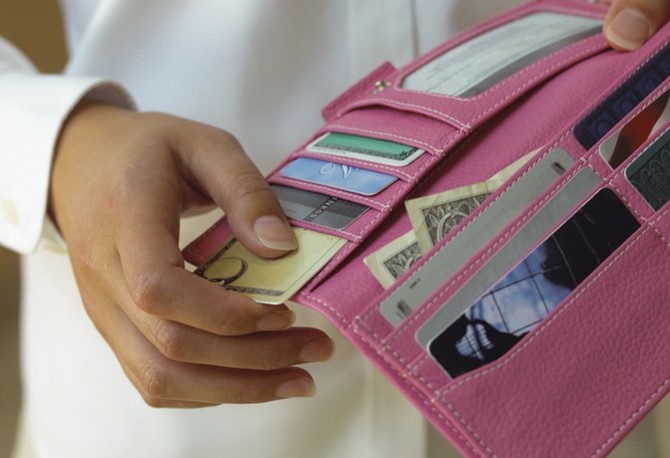 Woman holding wallet with credit cards