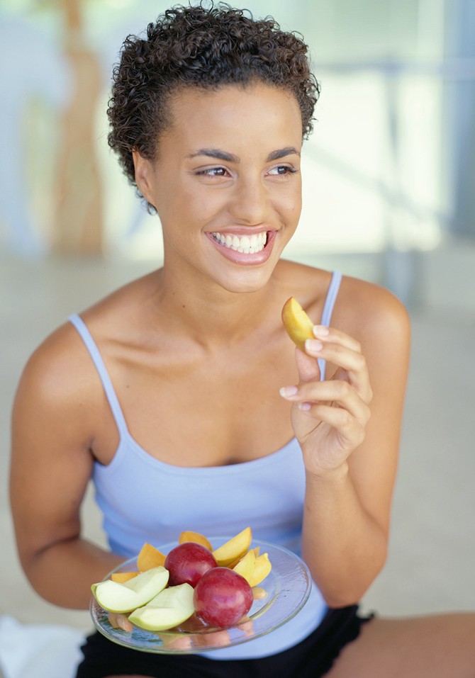 Woman eating fruit