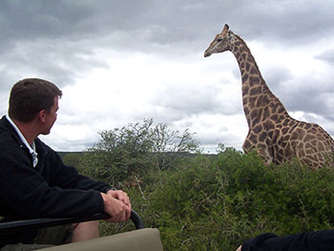 Security guard Jonathan gets close to a giraffe