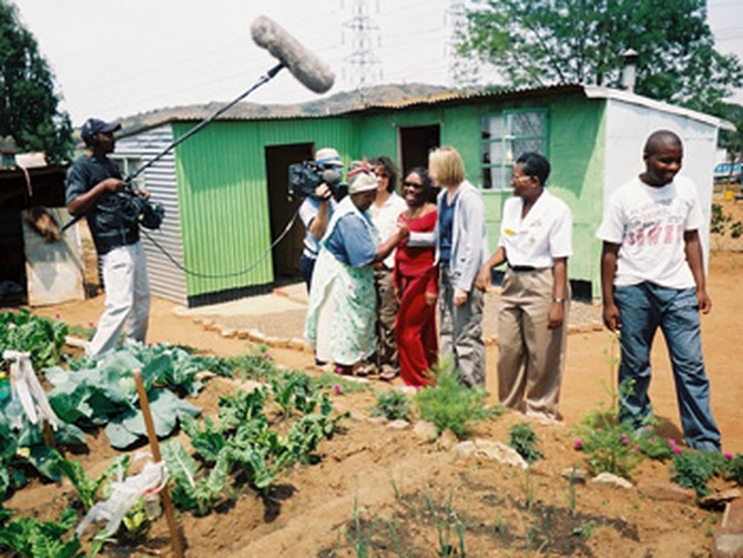 A woman in Motsoaledi South Africa tends her garden