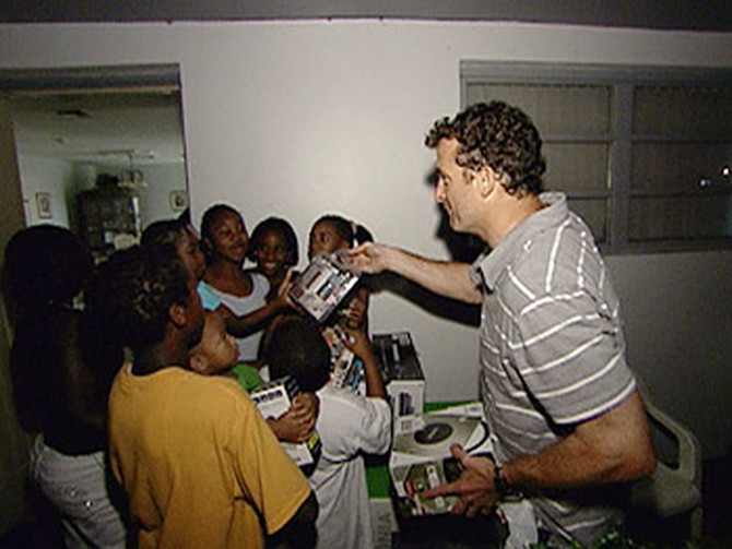 'Oprah's Big Give' contestant Stephen hands out electronics.