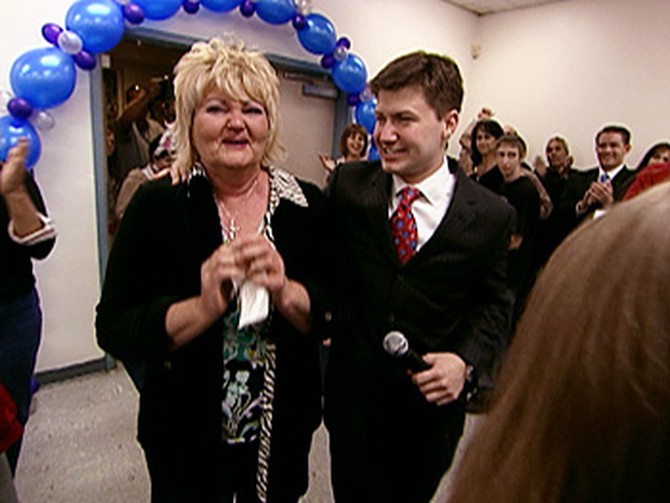Cameron surprises Karen with the reveal.