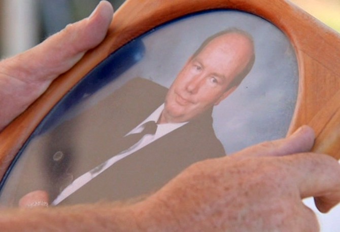 Peter holding a photo of Jenni's late father