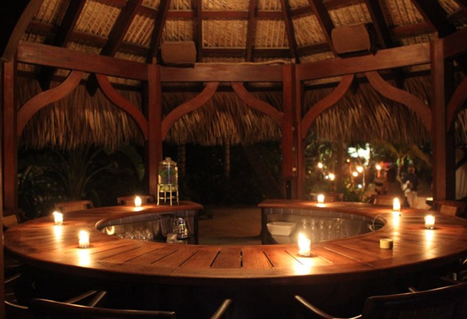 Poolside bar lit by candles on Musha Cay, David Copperfield's private island