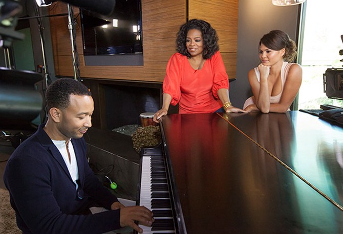 John Legend playing piano for Oprah Winfrey and Chrissy Teigen