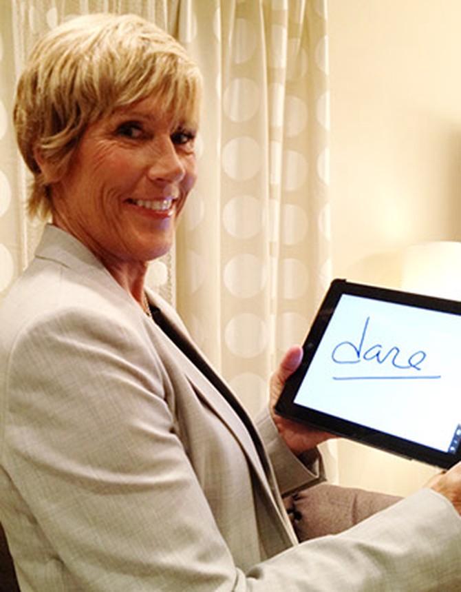 Long-distance swimmer Diana Nyad holding up "Dare" sign