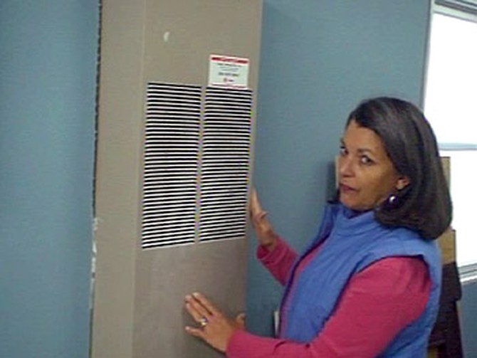 Stevie Brinkerhoff next to the faulty furnace she had replaced for a family