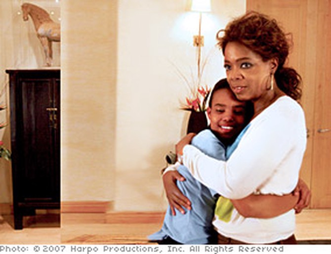 Oprah hugs Charlene.