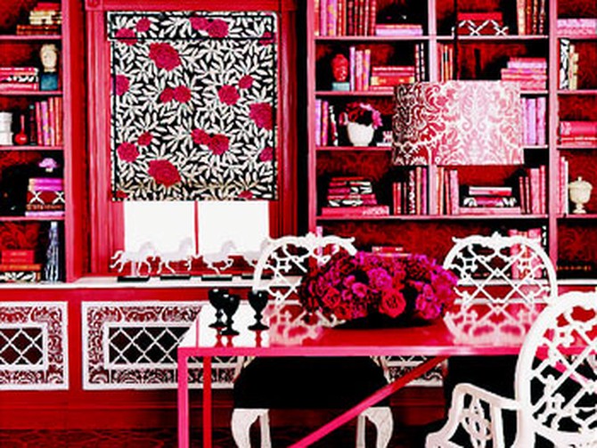 Red-on-red wallpaper in a library/dining room.
