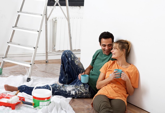 Man and woman taking a break from painting