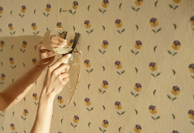 Woman peeling wallpaper
