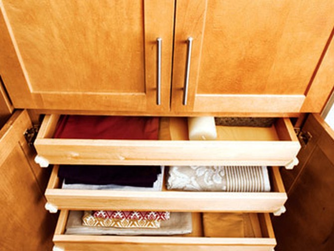 Linens and candles in drawers
