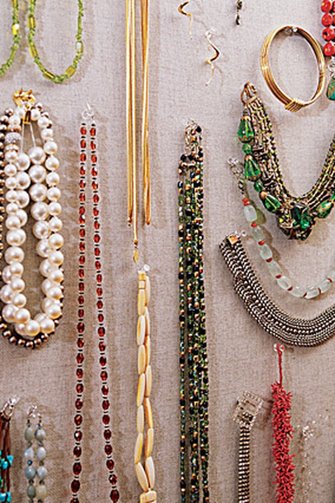 Kay Unger hangs her costume jewelry in a closet.
