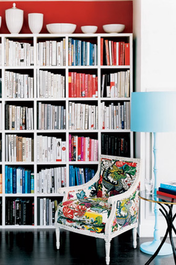 A red accent wall demarcates this nook as a library.