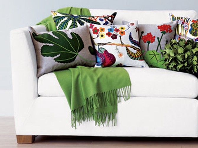 A mix of pillows covered in colorful plant imagery