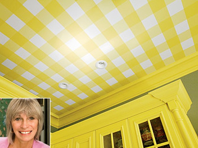 Elle uses yellow wallpaper on the ceiling to add color.