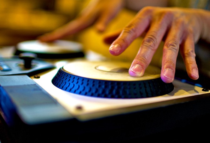 DJ's hands on the turntable