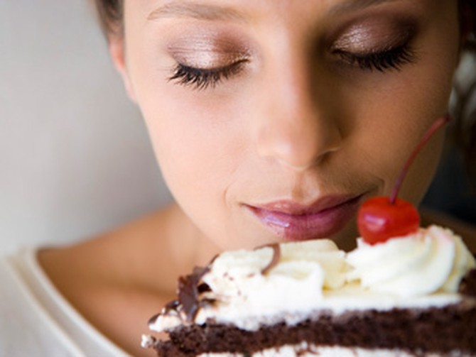 Woman thinking about eating cake